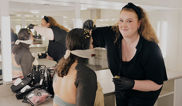 Megan applying screen make up to model